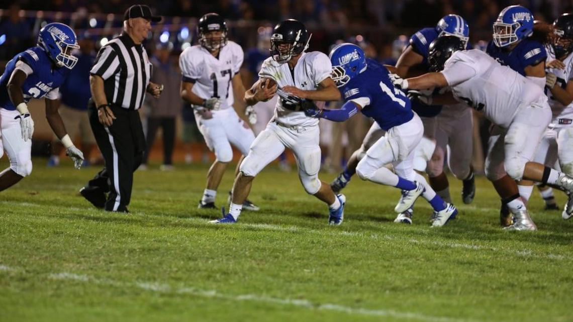 Arroyo Grande running back Cameron Johnston is dragged down by a Lompoc defender in a non-conference game Friday night in Lompoc. Johnston had 17 carries for 81 yards and a touchdown, all coming in the second half.