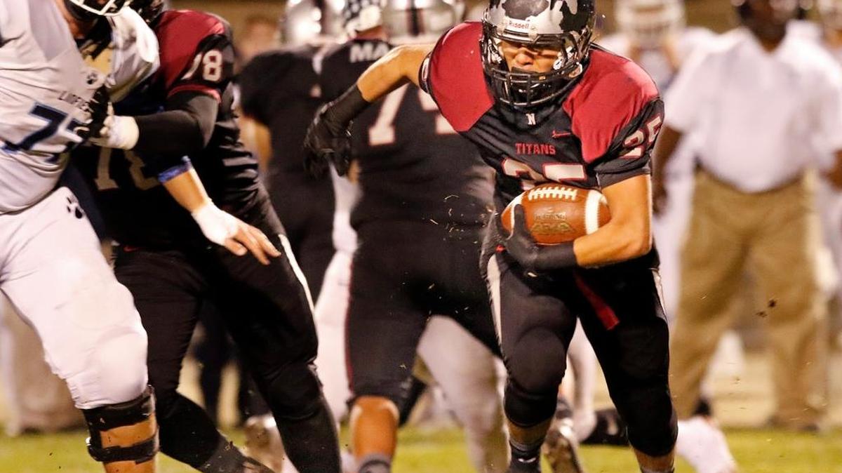 Nipomo High running back Antonio Navarro (25) gains some yardage during Saturday night’s playoff game.