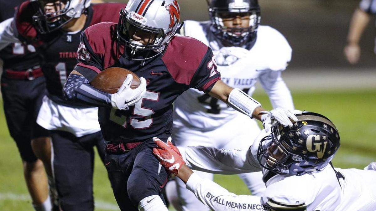 Nipomo's Luis-Diego Riquelme stiff arms Golden Valley’s Ahvie Harris in the first round of the CIF-Southern Section Division 6 playoffs Friday night.
