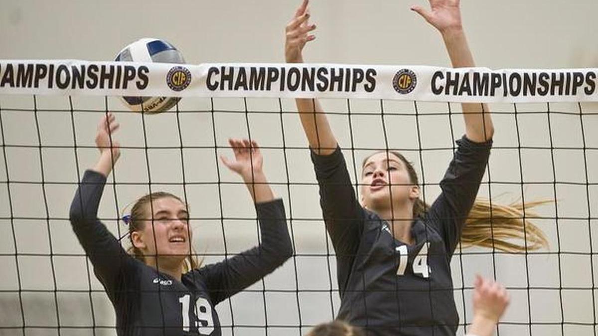 Saddleback Valley Christian’s Sydney Stratton and Shannon Geraty attempt a block during the CIF-Southern Section Division 3A girls volleyball final against Templeton at Rio Hondo College on Saturday night.