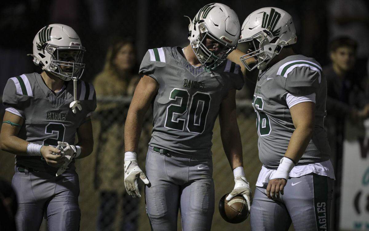 Tyler Cunningham, left, gets a congratulatory helmet bump from Aidan Wickstrom after a touchdown. Templeton beat San Luis Obispo High School 48-7 in a football game on Oct. 17, 2025.