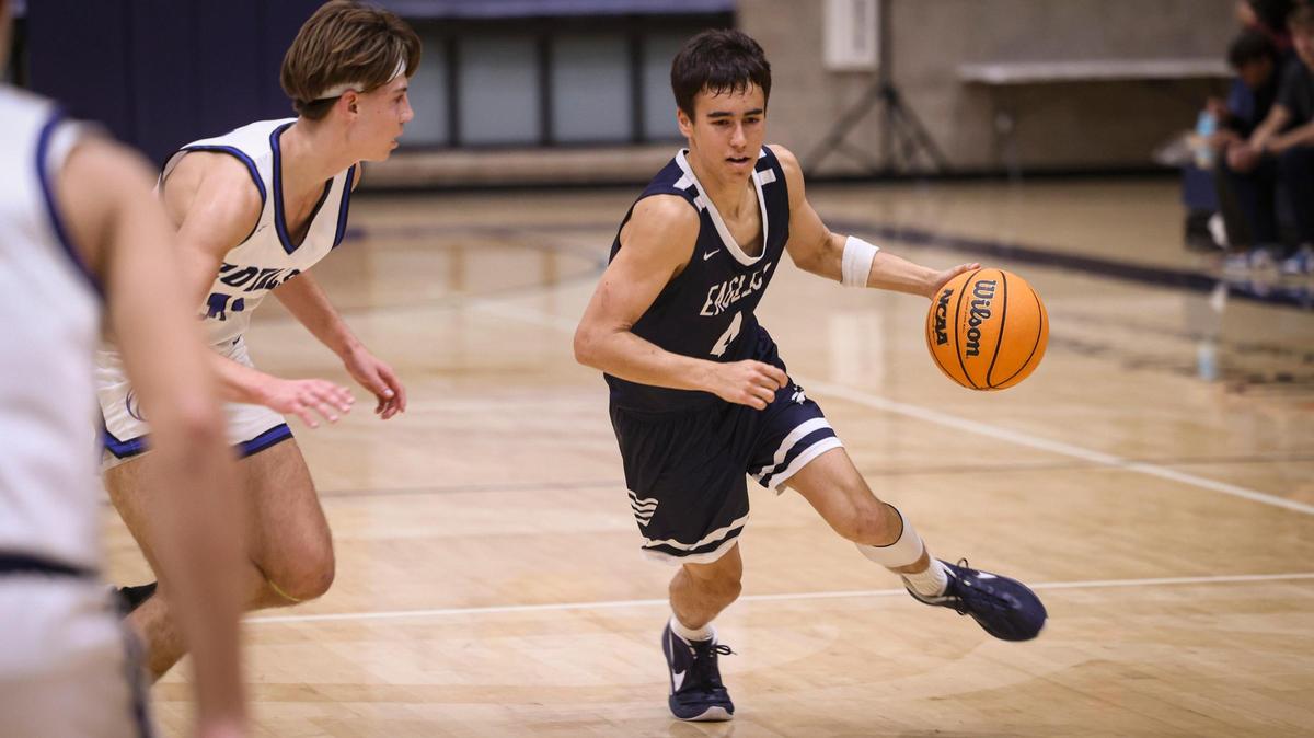 Grant Fordyce drives, Roman Benedetti defends. Mission Prep beat Arroyo Grande High School 61-44 in a boy’s baskeball game on Jan 10, 2025.