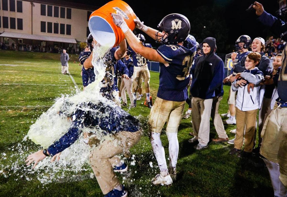 Mission Prep head coach David Schuster is doused with ice water in celebration of his team beating Fresno Christian for the Central Section CIF Les Schwab 8-man football championship.