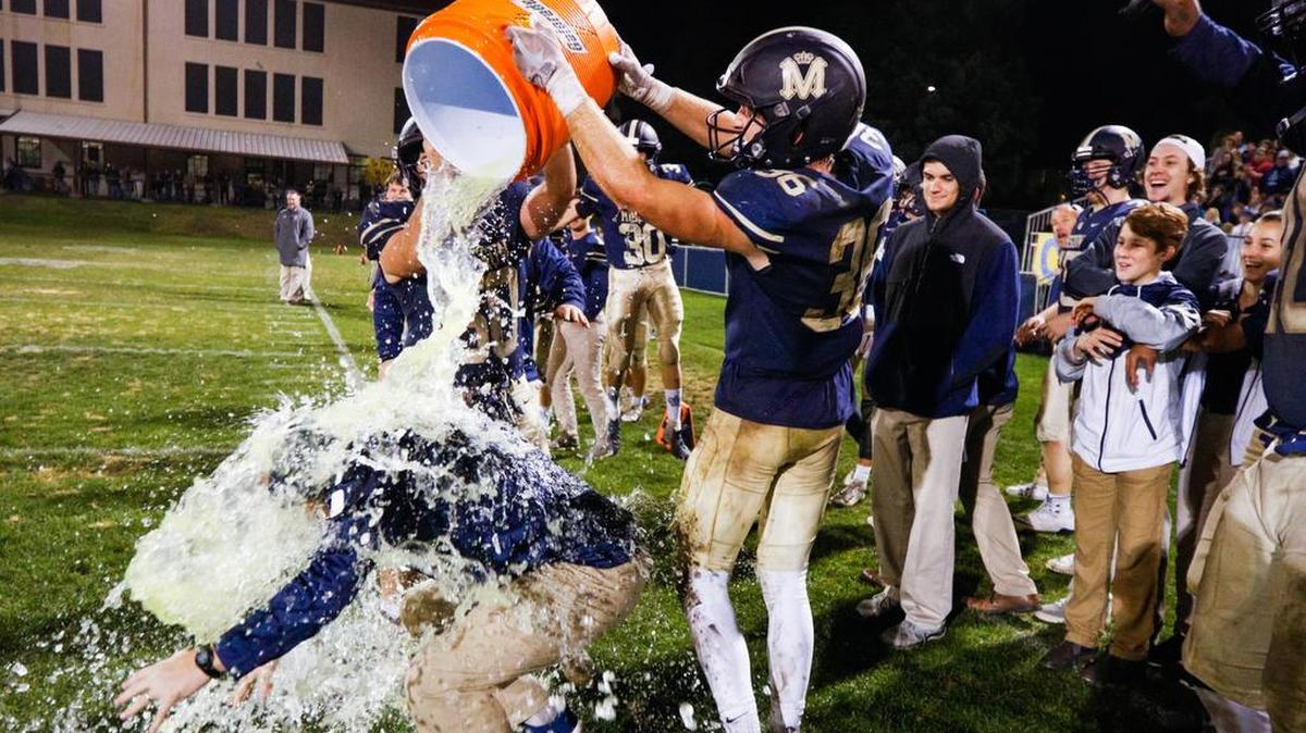 Mission Prep head coach David Schuster is doused with ice water in celebration of his team beating Fresno Christian for the Central Section CIF Les Schwab 8-man football championship.