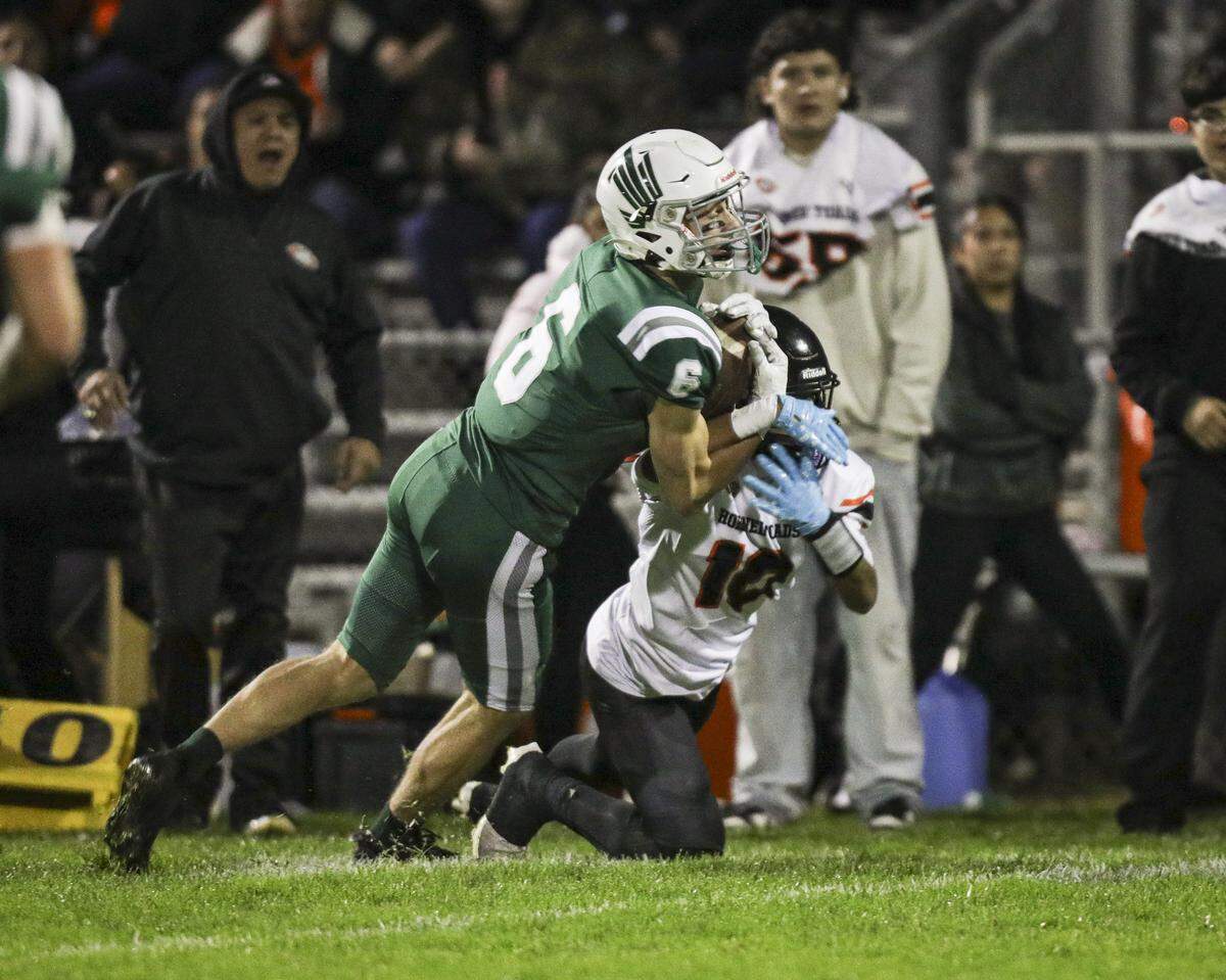 Cameron Stevens cuts in front of Korvallis White to make the catch.Templeton beat Coalinga 40-14 in a playoff football game Nov. 14, 2025.