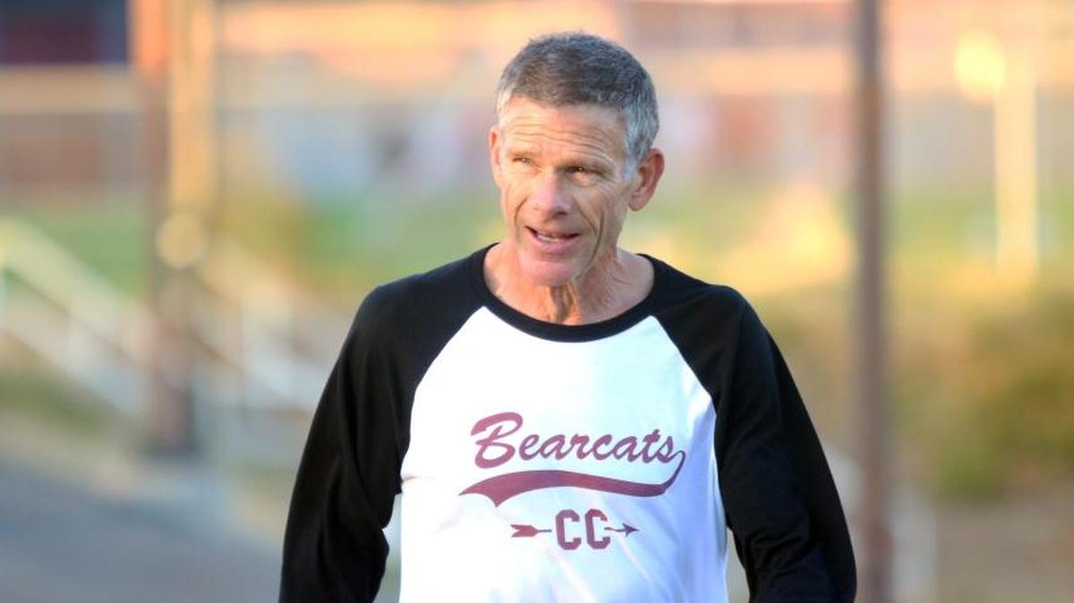 Paso Robles High School cross country and track and field coach Ivan Huff cools down after workout. Huff is the longest tenured coach at the school.