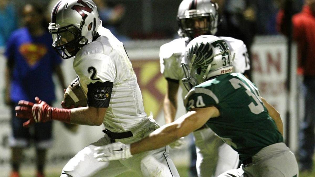 Nipomo High’s JJ Ramirez tries to get away from Templeton’s Angel Avelar during Friday night’s game.