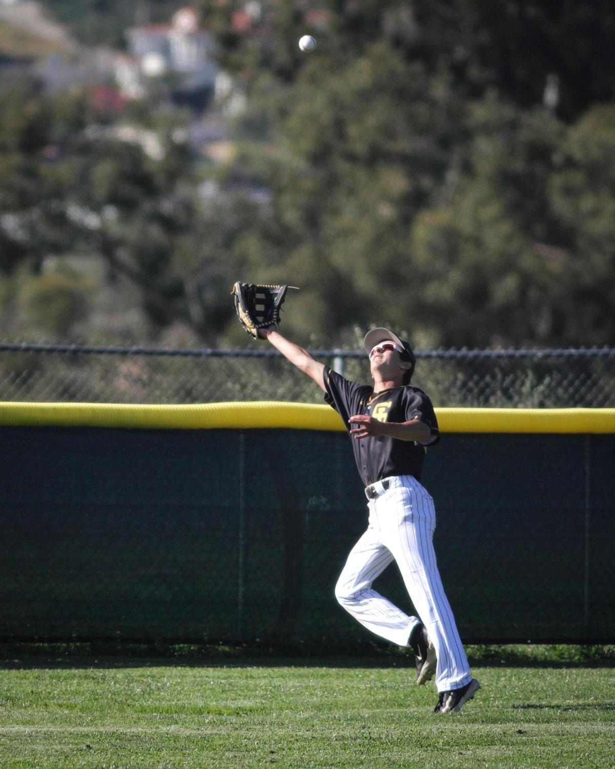 Noah Soderin makes a running catch near the fence for the Tigers. Morro Bay beat San Luis Obispo 8-5 on May 13, 2025.