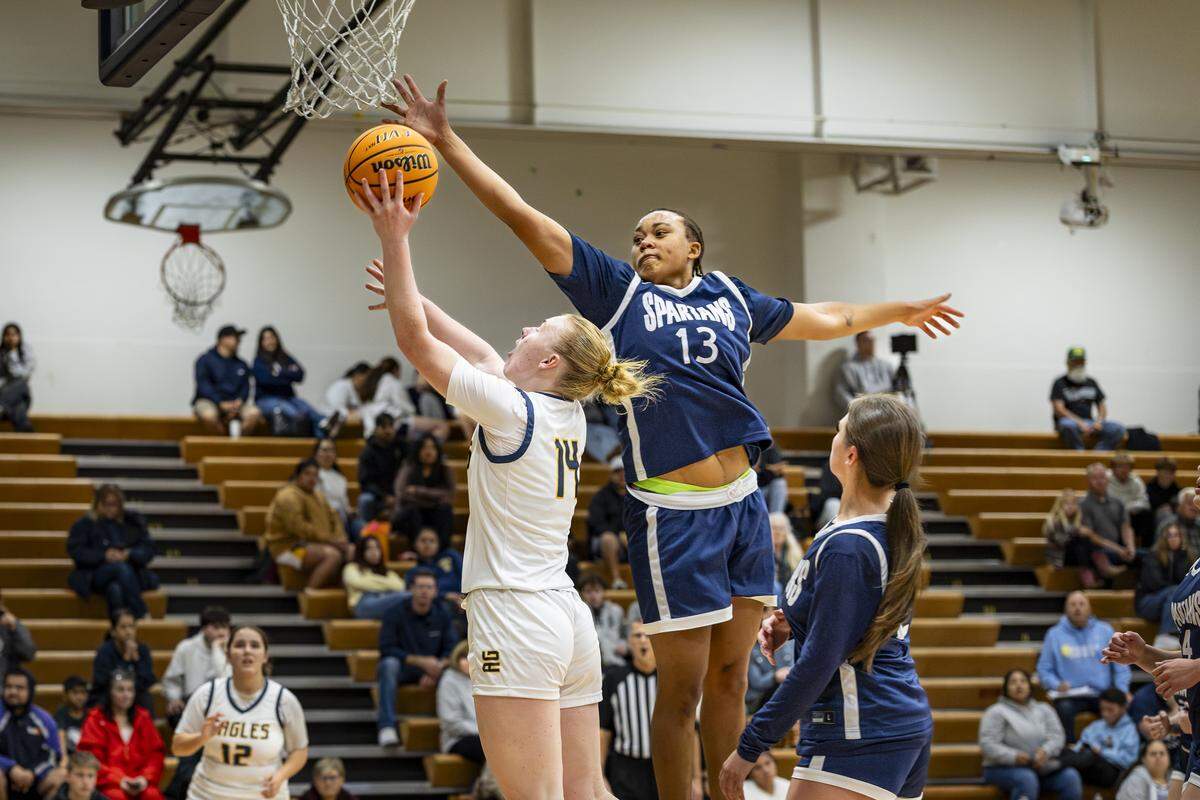 Ellie Sloan attempts a shot while avoiding Elizabeth Johnson, of Orcutt Academy.