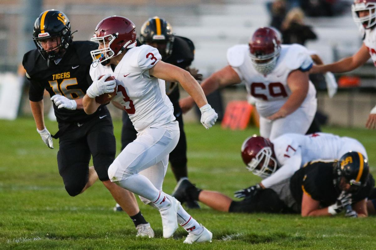 Jake Morones turns the corner for Paso Robles as Link Danninger pursues. San Luis Obispo hosted Paso Robles for the second game of the coronavirus shortened, late start to football season.