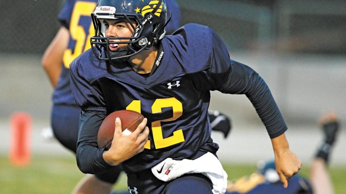 Arroyo Grande High quarterback Sawyer May runs for a first down in the first quarter of the Eagles’ loss to Camarillo on Sept. 12.