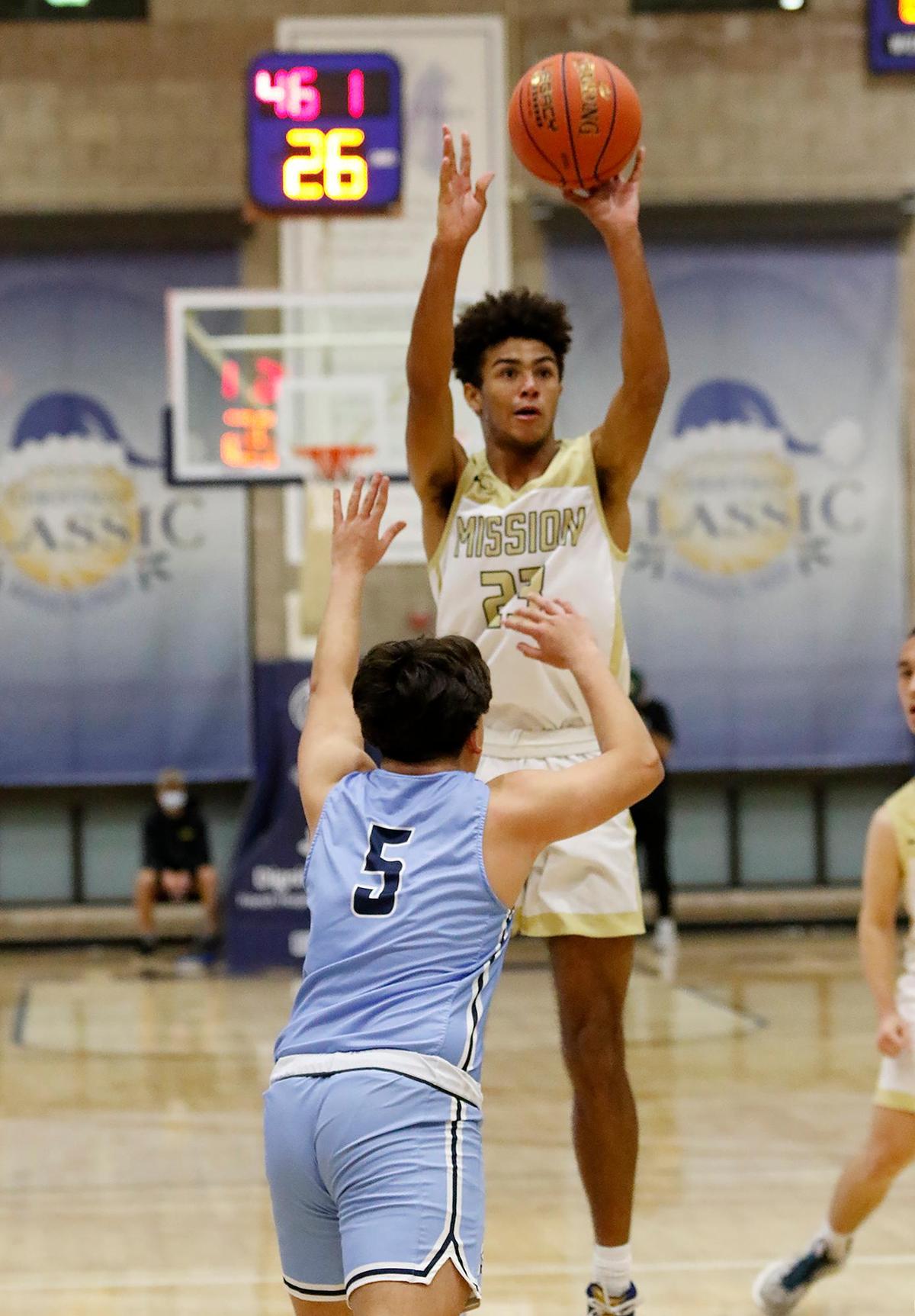 J.J. Howard (23) shoots over the Saugus Adrian Salazar (5).. The Mission Prep Classic basketball tournament is underway with some of the top teams in the state.