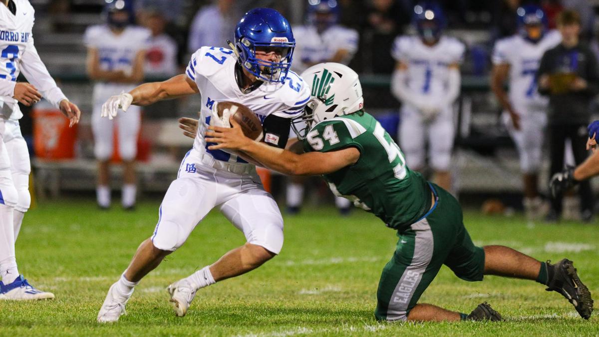 Morro Bay’s Dylan Turner runs as Templeton’s Johnny Peschong makes the tackle. The Pirates beat the Eagles 31-28 in overtime on Oct. 1, 2021.