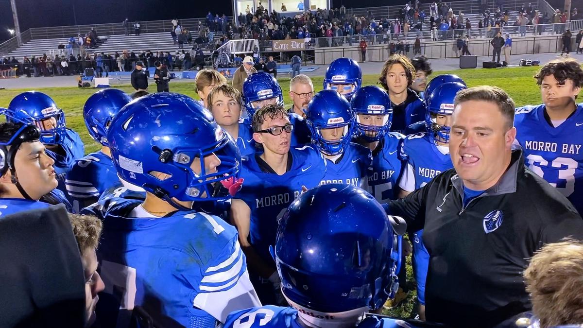 Head Coach Jake Goosen-Brown talks to team after Morro Bay defeated Loara High of Anaheim 35-27 in a state playoff game, Dec. 3, 2021.