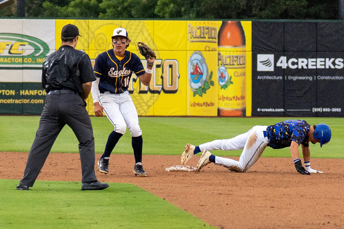 Ruben Servin shows the ball in the glove to the umpire.