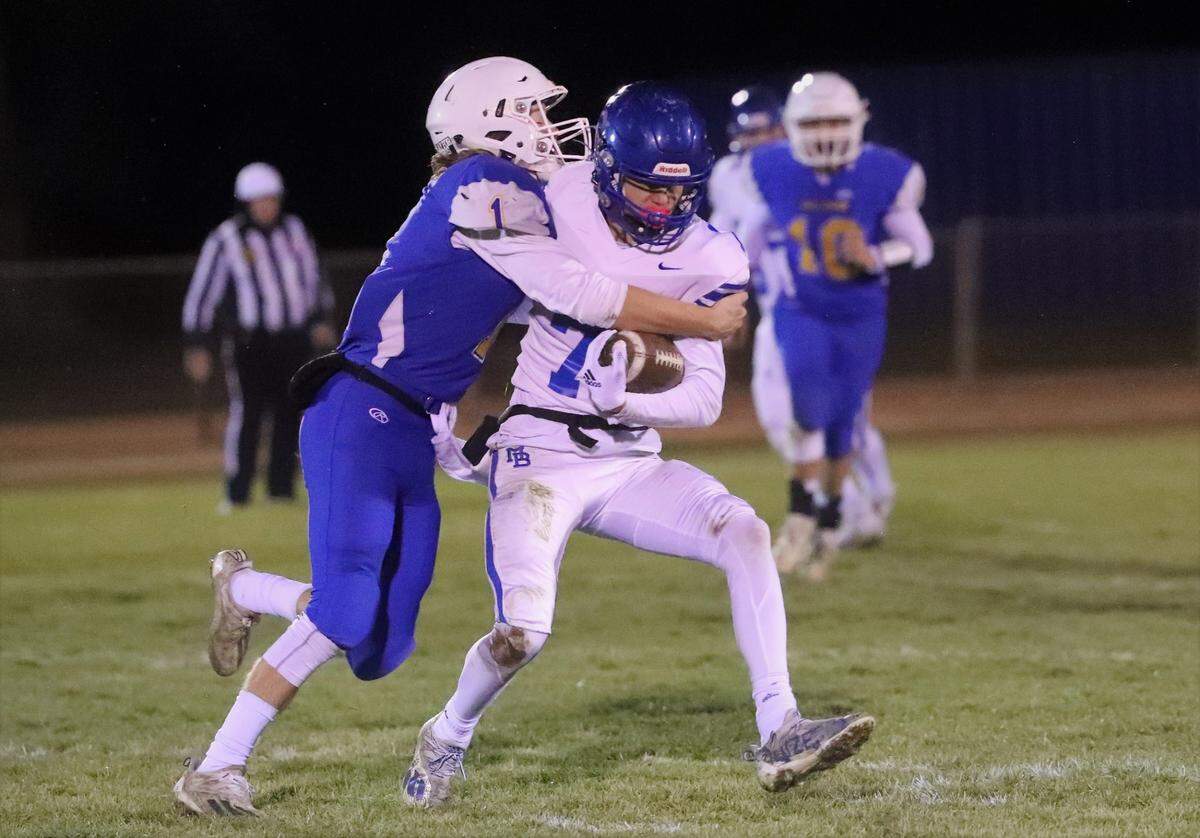 Morro Bay’s Ethan Lisman tries to break free from Fall River’s Evan Dobson in the Division 7-AA state championship at Fall River on Saturday, Dec. 11, 2021. Fall River won the state title 43-13.