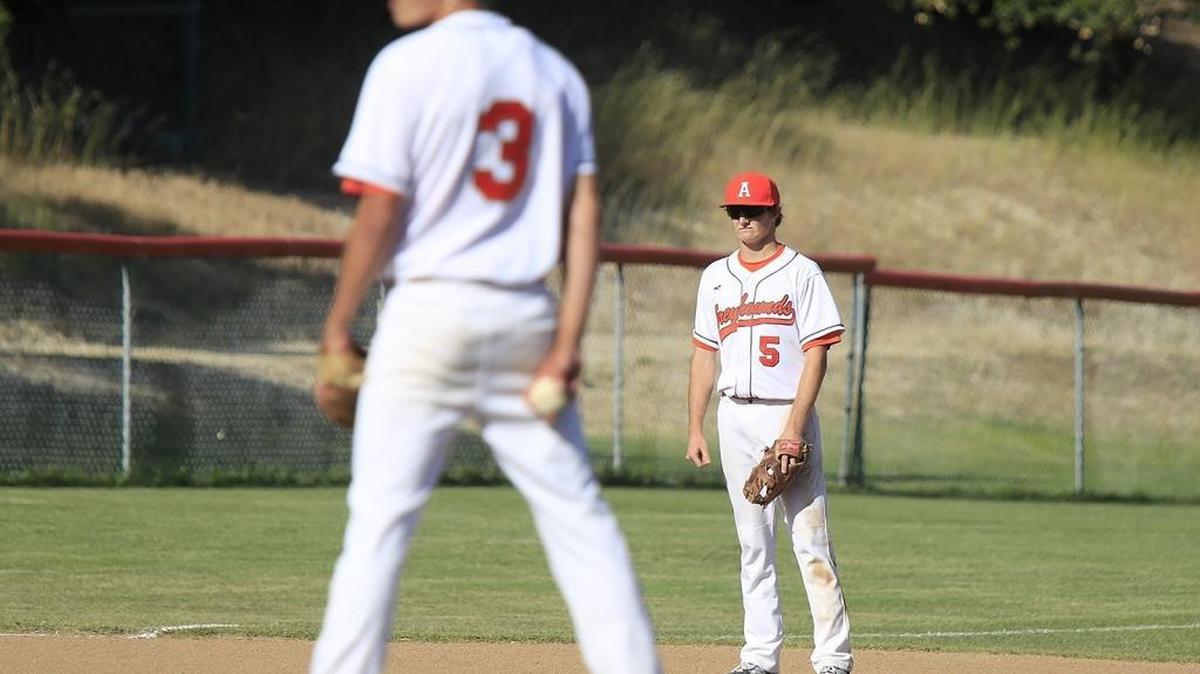 Atascadero High School loses 5 - 3 to Righetti at home, Friday, April 29, 2016. Atascadero’s Erdman (5) watches home plate as Atascadero’s starting pitcher, Lucas Sprouse (3), sizes up his next pitch. (Photo by Laura Dickinson)