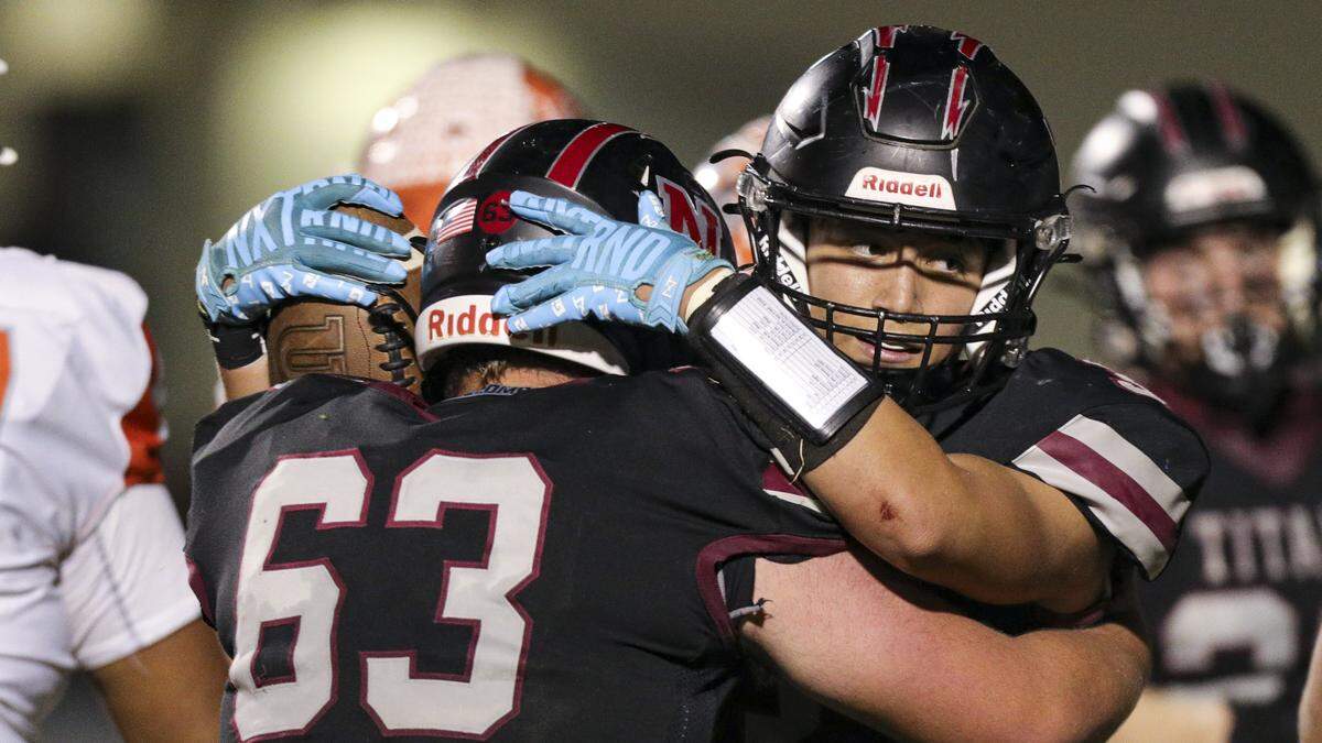 Peyton Blume congratulates Nick Evans after the Titan running back scored. Nipomo beat Atascadero 35-34 in a double-overtime playoff football game on Nov. 7, 2025.