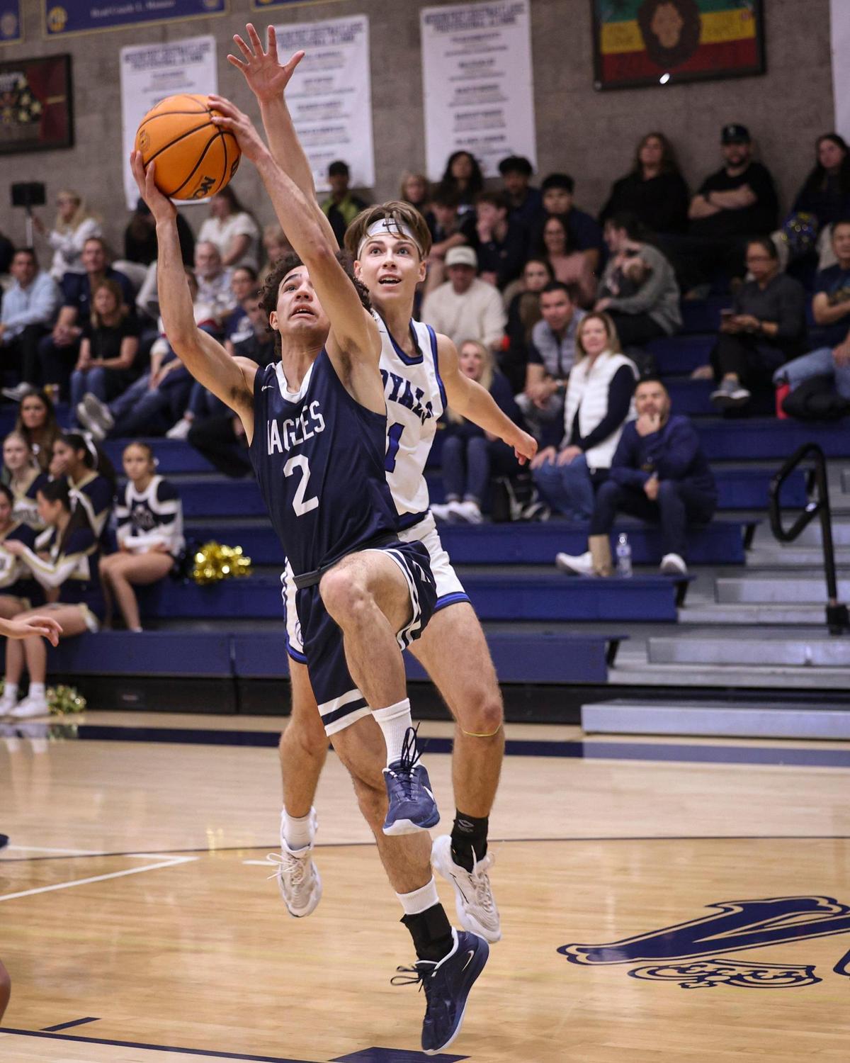 Zayne Ellison shoots, trailed by Roman Benedetti. Mission Prep beat Arroyo Grande High School 61-44 in a boy’s baskeball game on Jan 10, 2025.