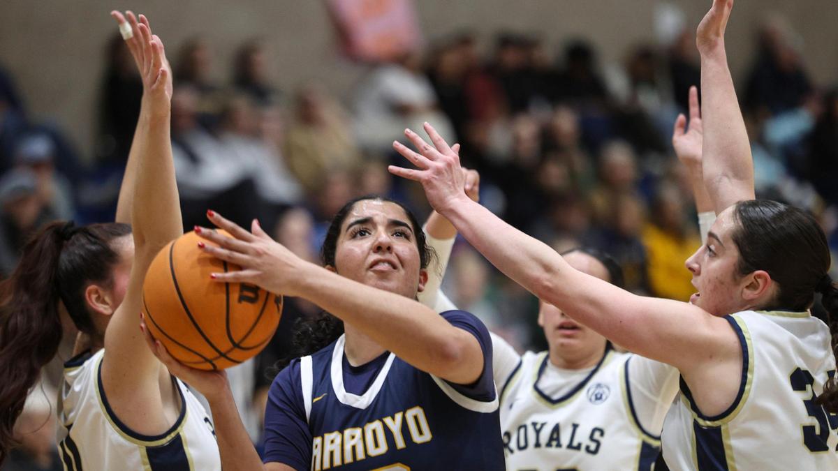 Kinzie Amer takes a shot between Mission defenders. Mission Prep girl’s basketball team beat Arroyo Grande 55-51 on Feb. 11, 2025.