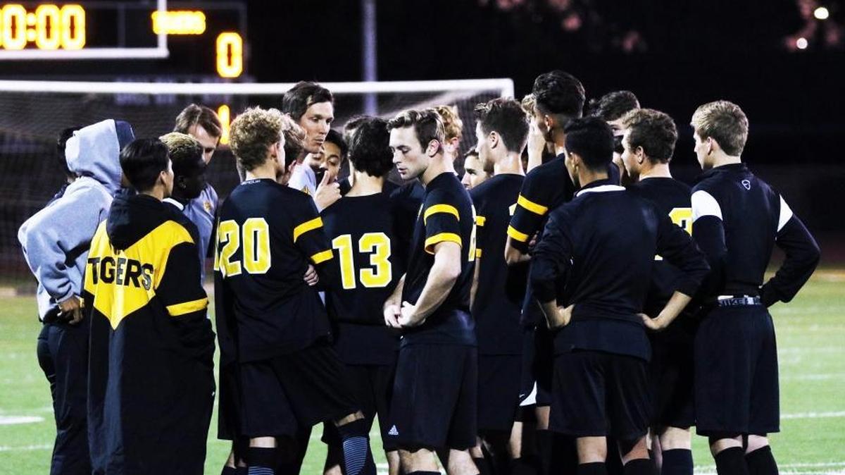 The San Luis Obispo High School boys soccer team’s leading goal-scorer, Branden Dolezal (center), stands with his team before the start of its final regular season game in 2018 against St. Joseph.