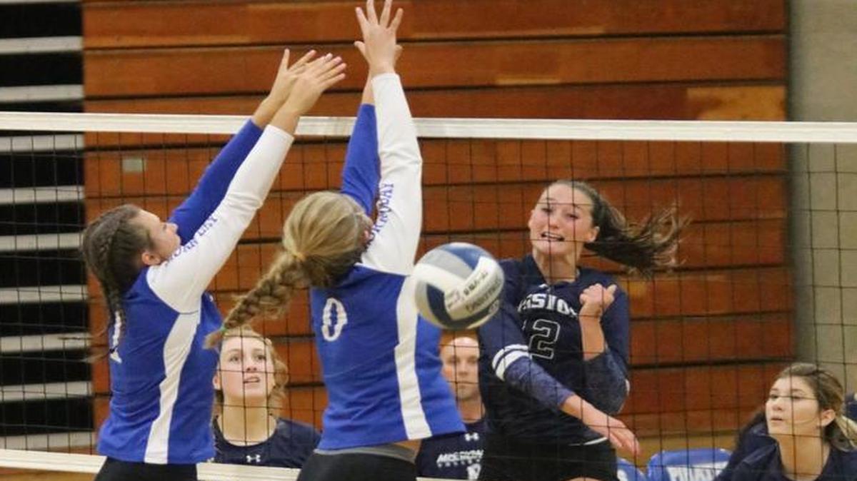 Mission Prep’s Jennifer “Boo” Laird puts a kill past two Morro Bay defenders.