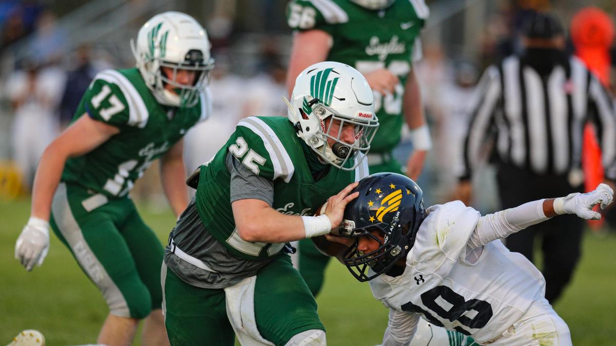 Tyler Kaschewski pushes away Joshua Brock. Templeton High School hosted Arroyo Grande in a battle of the Eagles football teams.