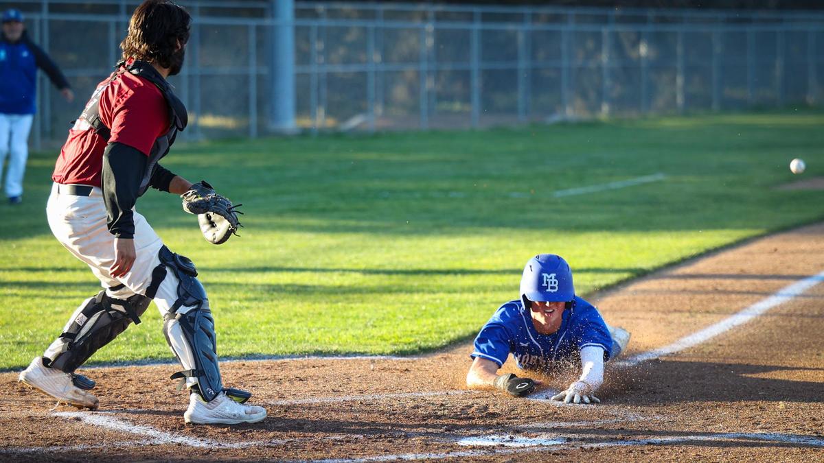 Nicky Johnson scores the Pirate’s first run after the throw got by the third baseman. Morro Bay Pirates won 11-1 over Nipomo Titans in boys high school baseball March 22, 2022.