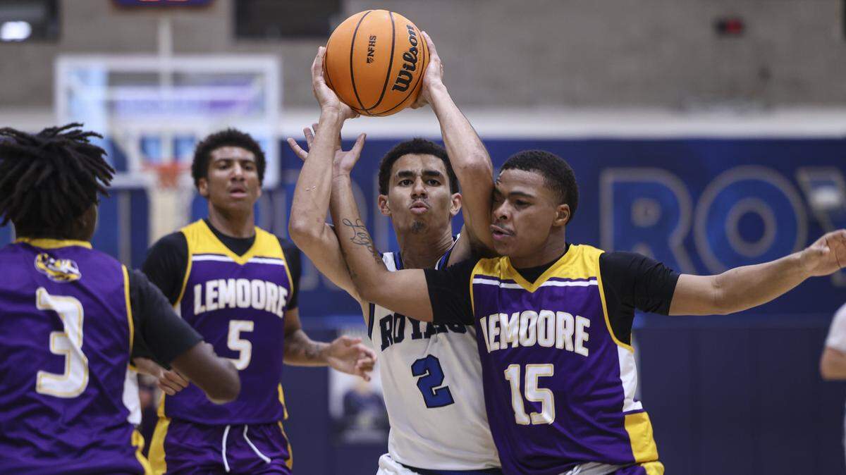 Duece Kellog is surrounded by Tigers, Jaimeir Campbell, left, Jacoby Notah and Larry Logan III. Mission Prep boy's basketball team beat Lemoore 69-43 on Feb. 13, 2026 in the first game of ;the playoffs.