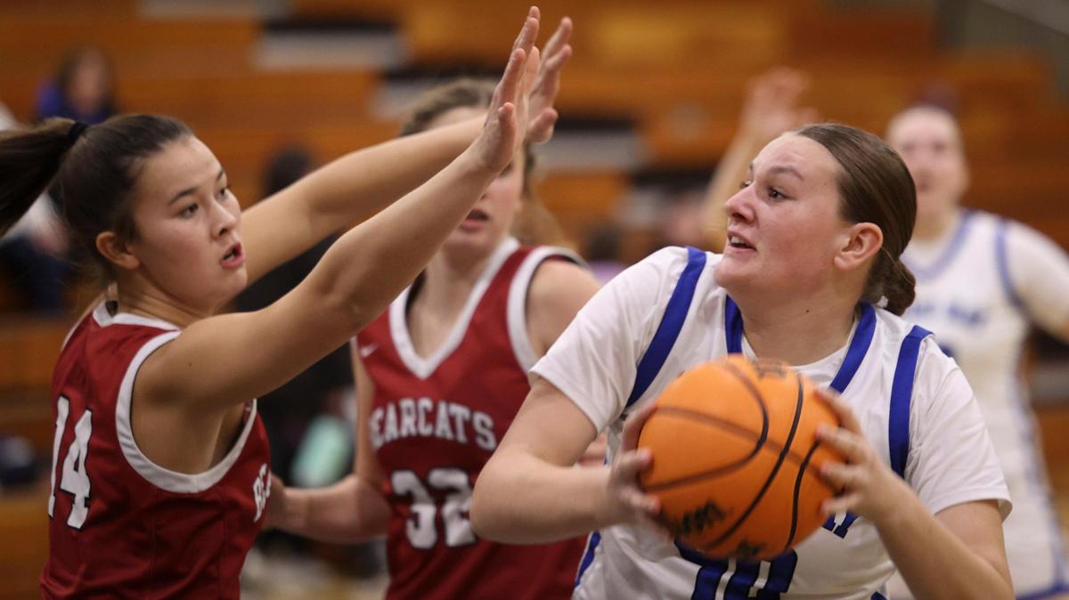 Kate Harrington defends as Tailer Morrison moves to shoot. Morro Bay girls basketball beat Paso Robles 47-38 on Jan. 9, 2024.