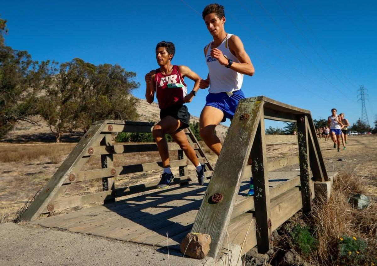 Paso Robles junior Pablo Cortes (left) and Arroyo Grande senior Luis Jazo compete at the San Luis Obispo County cross country meet at Laguna Lake Park on Oct. 26. The duo qualified for the CIF-Southern Section Finals over the weekend.