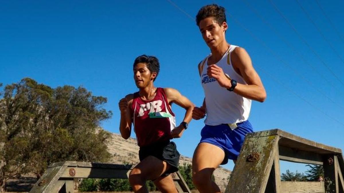 Paso Robles junior Pablo Cortes (left) and Arroyo Grande senior Luis Jazo compete at the San Luis Obispo County cross country meet at Laguna Lake Park on Oct. 26. The duo qualified for the CIF-Southern Section Finals over the weekend.