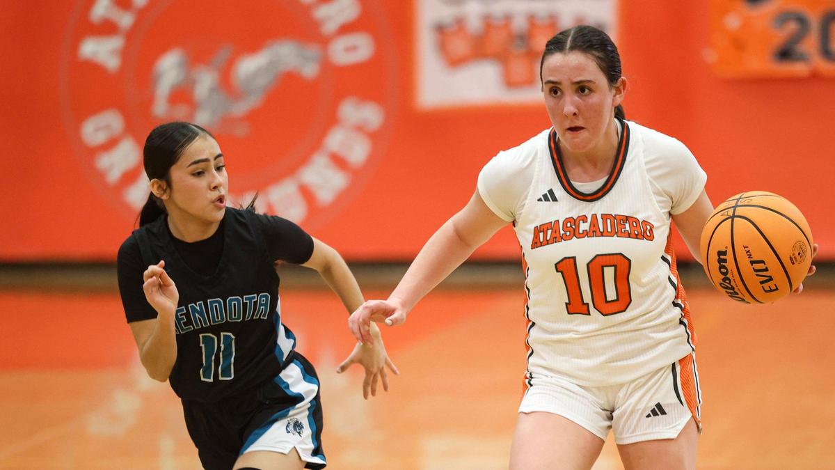 McKenna Nichols dribbles as Valeria Sandovbal trails. Atascadero girls beat Mendota in a playoff basketball game on Feb. 18, 2025.