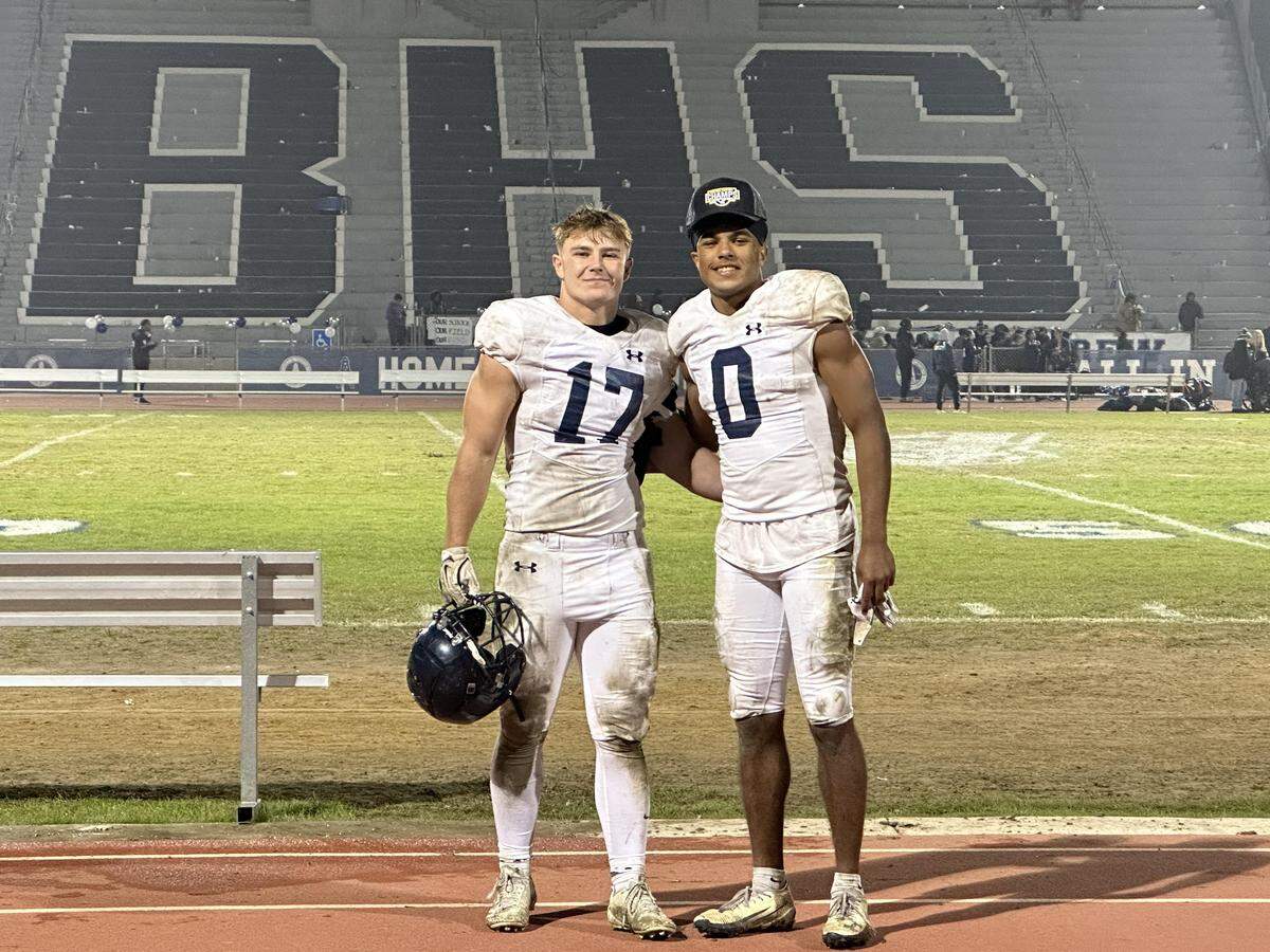 Zack Tayman (left) and Caleb Clark (right) after the 23-20 overtime CIF-Central Section Divison 2 win over Bakersfield for the title.