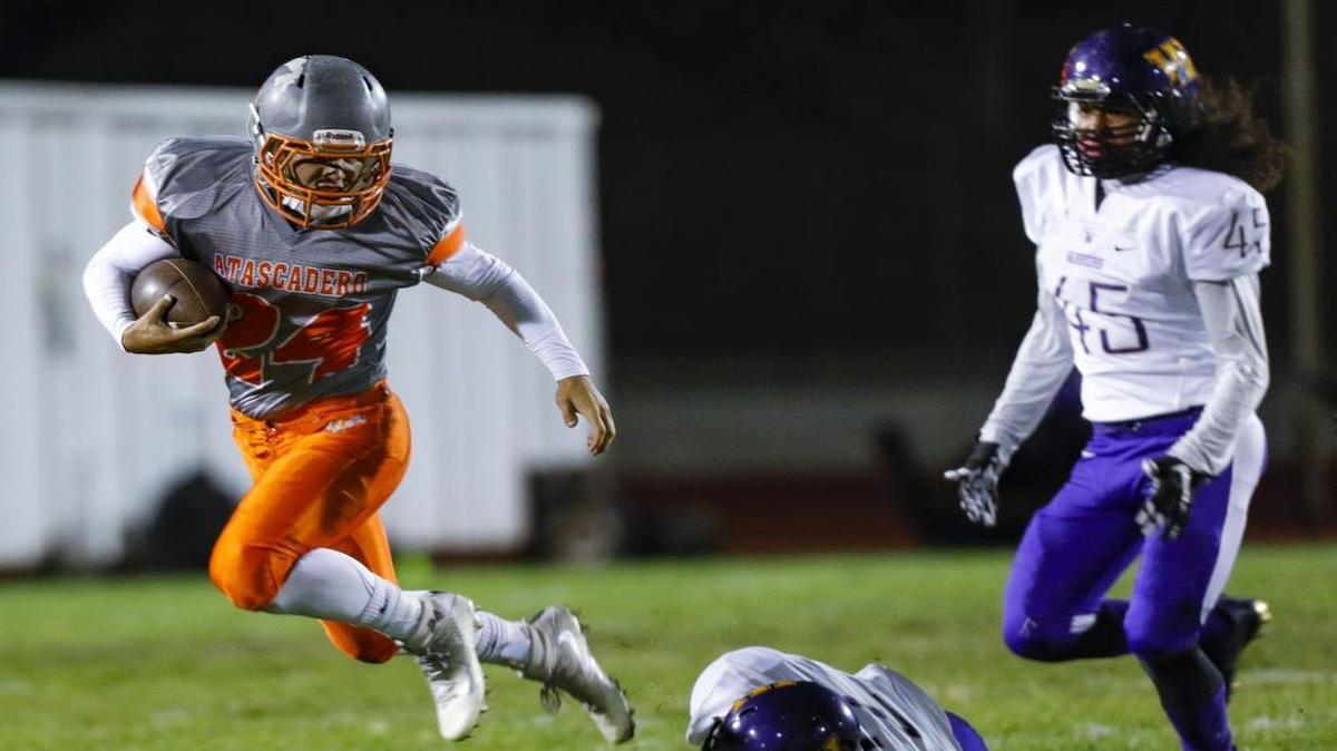 Arik Machado runs as Atascadero High football hosts Righetti in a PAC 8 game.