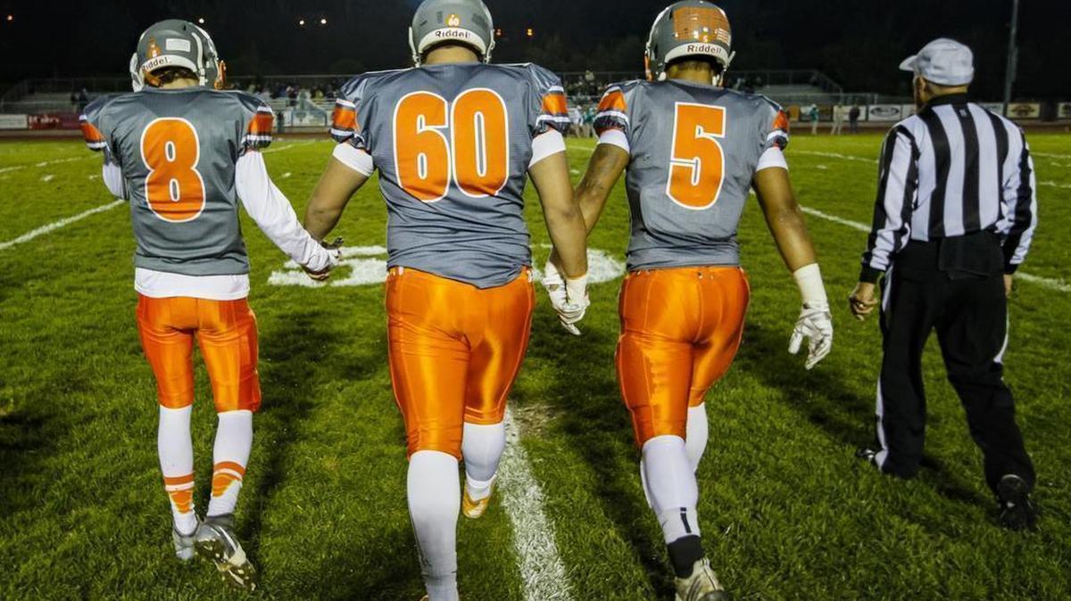 Atascadero High’s Zach Quigley, Kevin Blodget and Marc Martin walk onto the field before the Greyhounds’ playoff game against St. Joseph on Friday night.