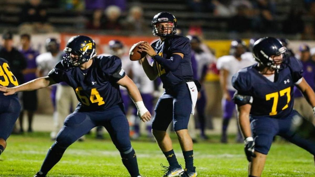 Aaron Teixeira (64) and Zach Burkhard (77) block for quarterback Sawyer May (middle) in Arroyo Grande’s Oct. 21 PAC 5 game against Righetti in Arroyo Grande