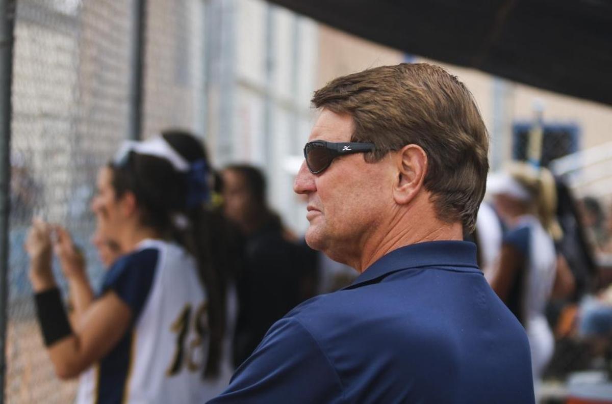 Arroyo Grande High athletic director Dwight MacDonald stands in the dugout during a softball game between Arroyo Grande and San Luis Obispo in May.