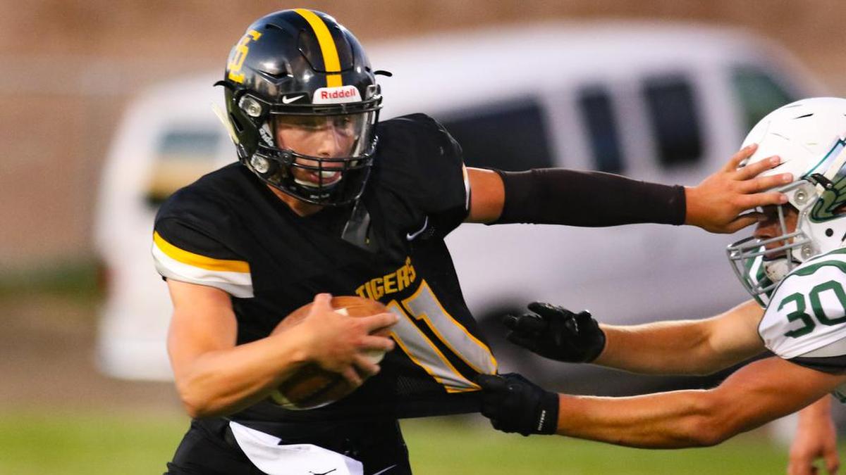 San Luis Obispo High School quarterback Emelio Corona eludes Templeton’s Cody Blankenship attempting to make a shirt tackle in week 4 of the high school football season.