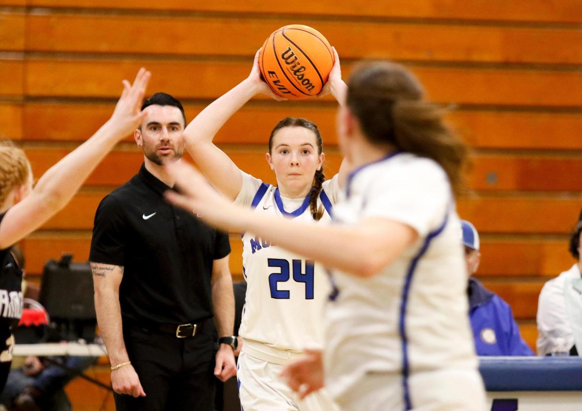 Morro Bay High School girls basketball team beats Rancho Cucamunga 49 - 29 in the CIF state playoffs at Morro Bay High School, Tuesday, Feb. 27, 2024. Morro Bay High School basketball coach Alex Engel concentrates on the game behind Violet Pace (24).