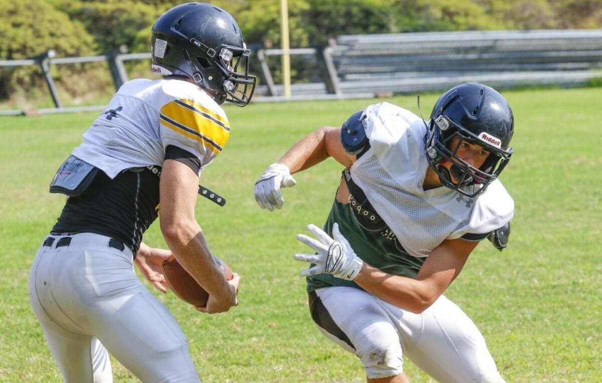 Back up quarterback Tegan Rawlins (left) fakes a hand off to running back Pierson Mosichuk David Middlecamp 7-22-2016