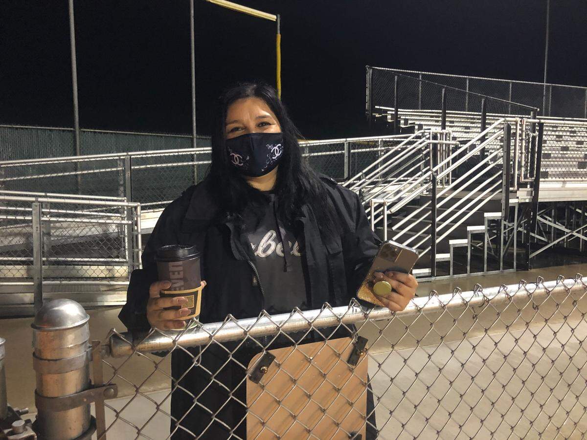 Melissa Sanchez cheers on the Arroyo Grande High School football team earlier this season. Her son, Adrian, played despite losing his father in a drowning accident at Lopez Lake in October 2020.