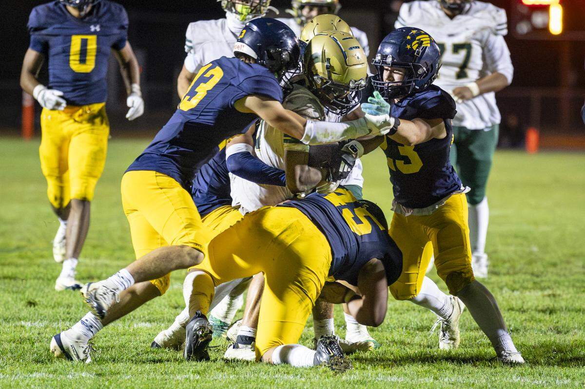 Arroyo Grande defenders team up to tackle a Garces Memorial ball carrier in a 42-29 win over Garces Memorial.