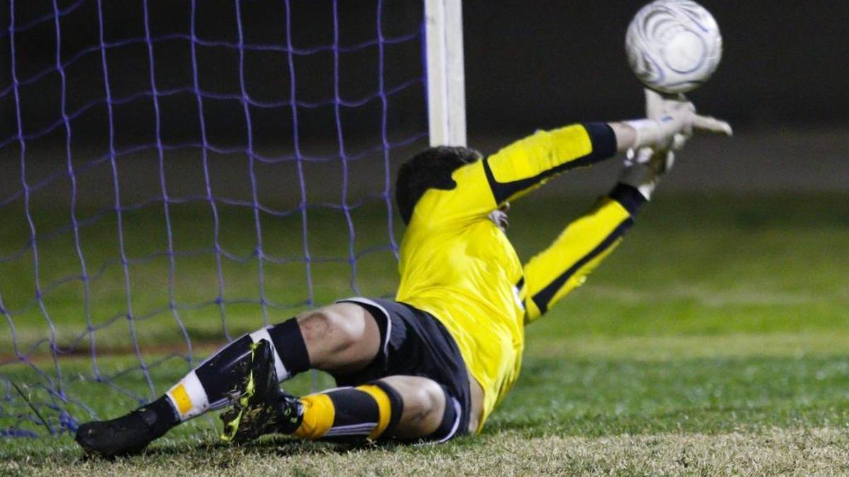 Elijah Herrera deflects a PK with his fingertips. Arroyo Grande hosted Santa Barbara in a boy's soccer match.