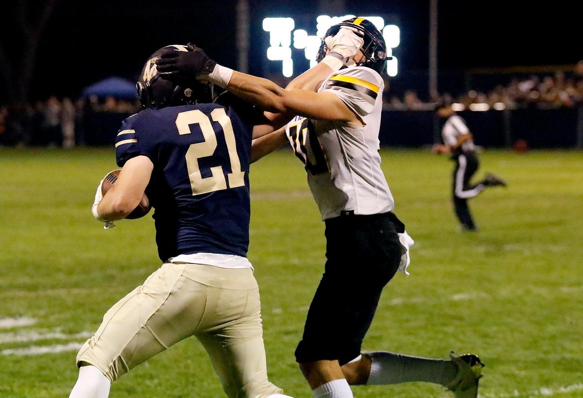 Mission Prep’s Drew Harrigan (21) stiff-arms San Luis Obispo’s Eli Smiley Rooney (10). Mission Prep beat San Luis Obispo High School 35-7 on Friday, Oct. 29, 2021.