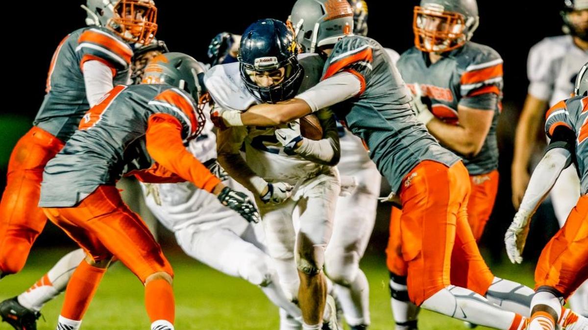 Atascadero defenders surround Arroyo Grande running back during an game in October.