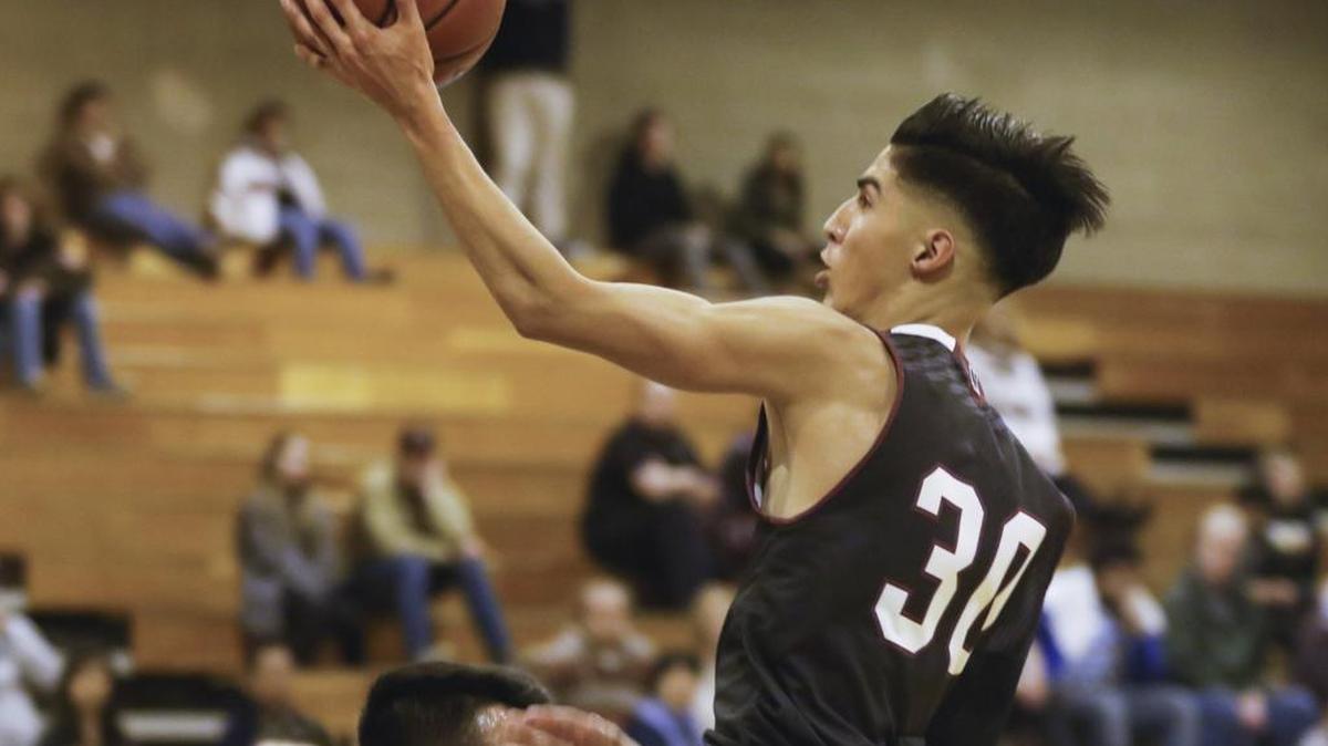 Nipomo High’s Mason Gallegos scores and gets a blocking foul on Marjoe DeLa Cruz.
