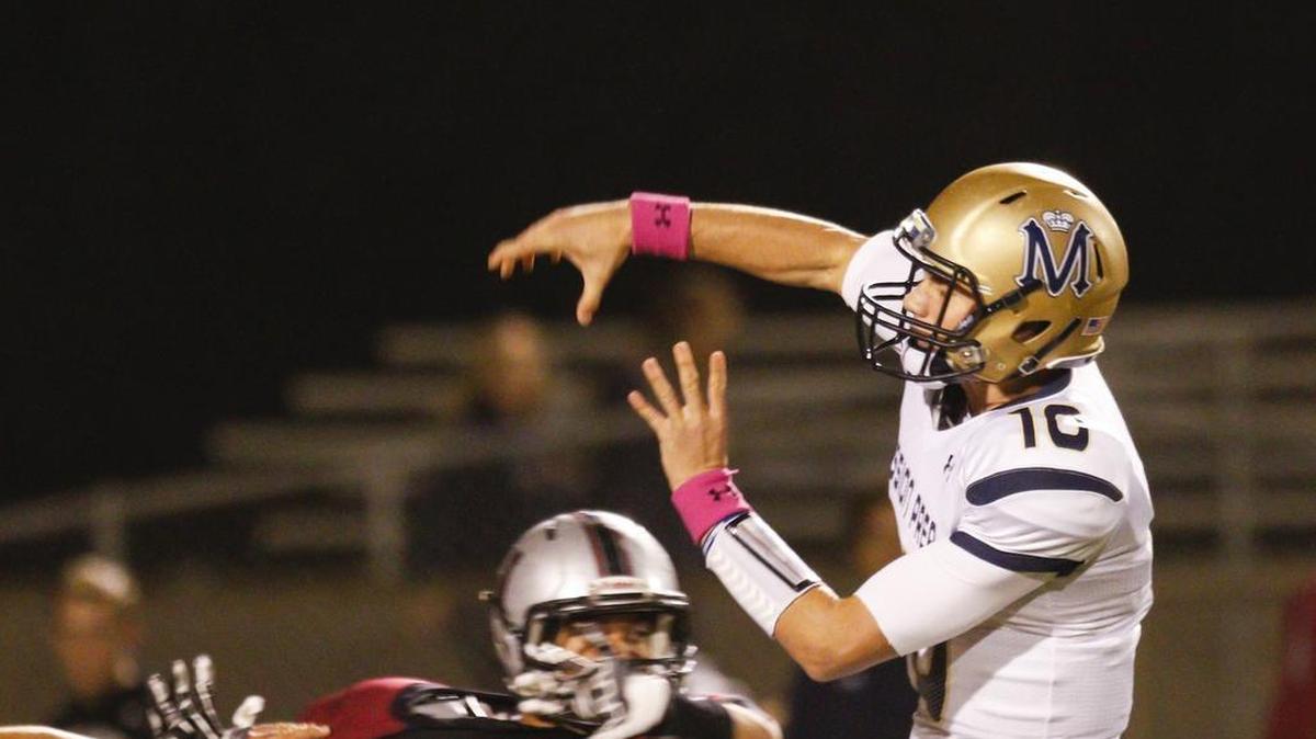 Mission Prep quarterback Bryce Fledderman throws a pass under pressure from Nipomo High’s Terry Wambolt during the Royals’ 24-7 win Friday night in Nipomo.
