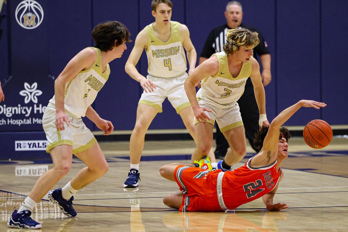 Corbin Rossi dives for the ball surrounded by Grant Callahan, Luke Jacobson and Jude Callahan. Mission Prep defeated Atascadero 74-65 in San Luis Obispo Jan.28, 2022.