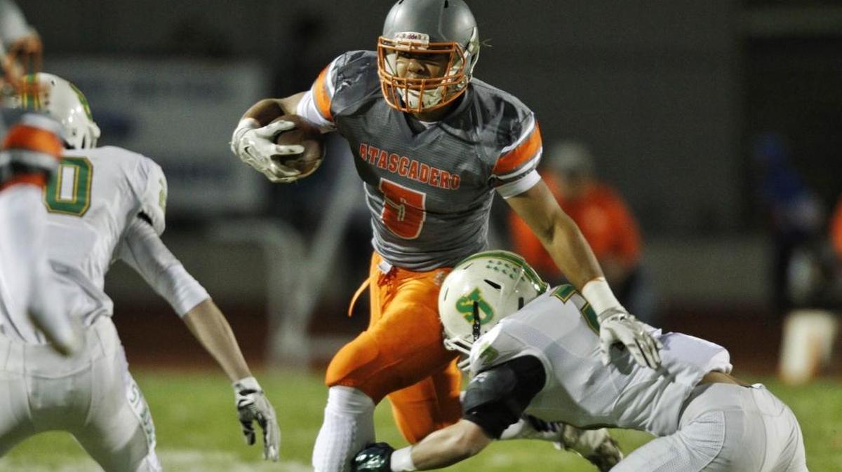 Atascadero High’s Marc Martin tries to break a tackle after making a catch during Friday night’s CIF-Southern Section Northern Division playoff game in Atascadero.